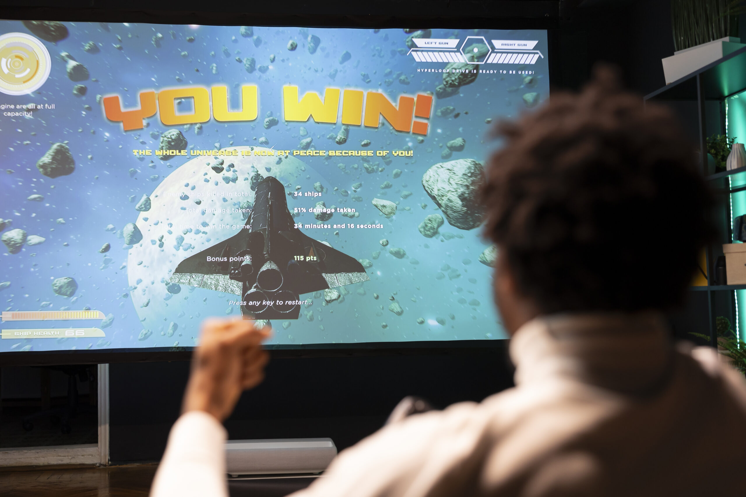 Gamer excited after winning online multiplayer game match on ultrawide smart TV