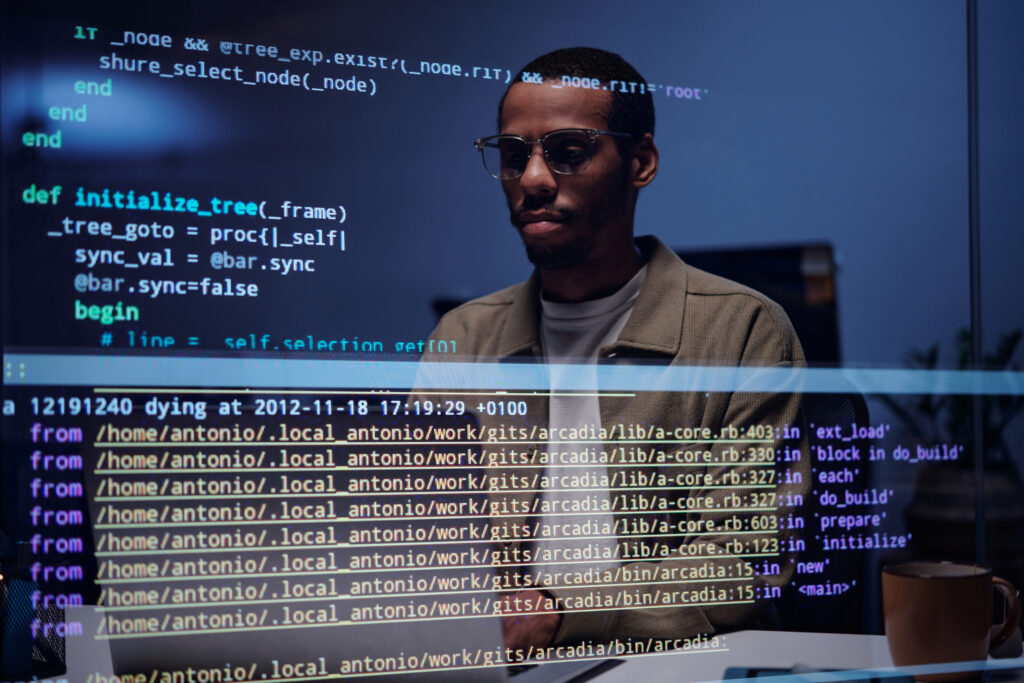 Analyzing Code on Computer Screen in Dark Office